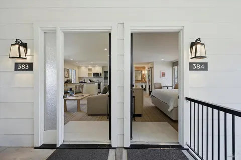 a bedroom with a large bed and a flat tv screen on dresser