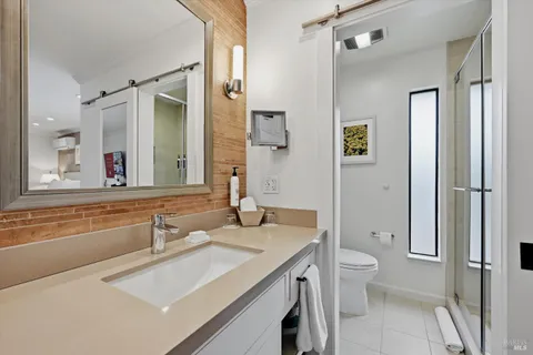 a en suite bathroom with a granite countertop sink toilet and shower