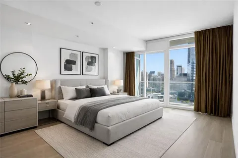 a bedroom with a large bed and a window
