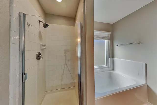 a bathroom with a glass shower door