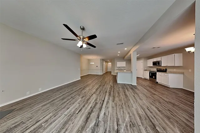 a view of a kitchen with a sink and wooden floor