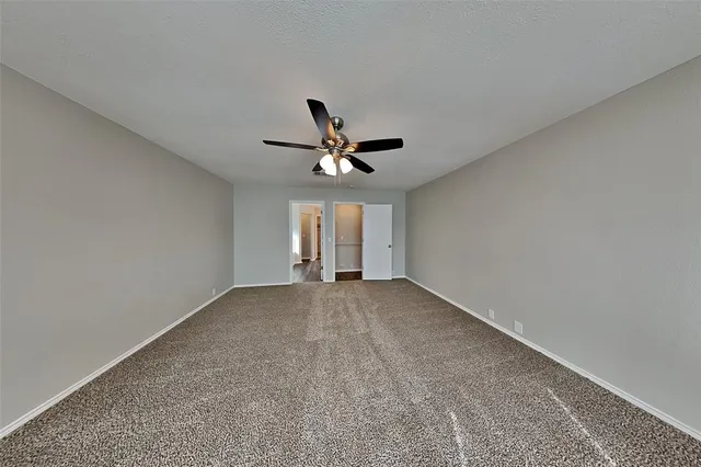 a view of a livingroom with a ceiling fan and window