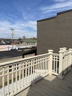 a view of a balcony with wooden floor and fence