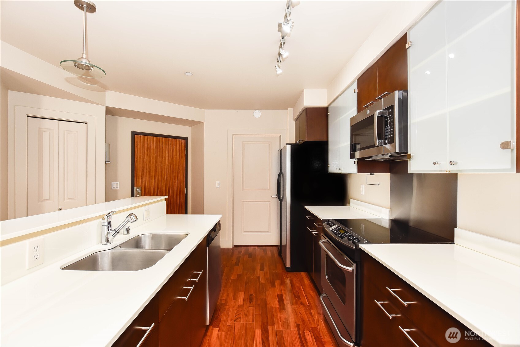 159 Denny Way, Unit 402 Seattle, WA 98109 - Photo 10 of 23 a kitchen with stainless steel appliances granite countertop a sink stove and refrigerator