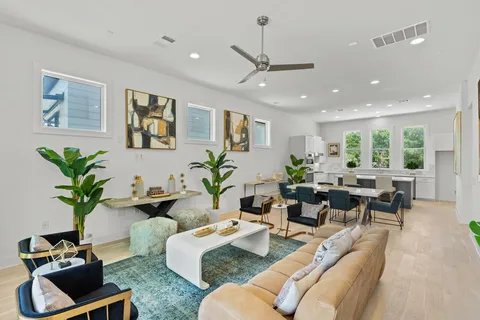 a living room with furniture potted plant and a window