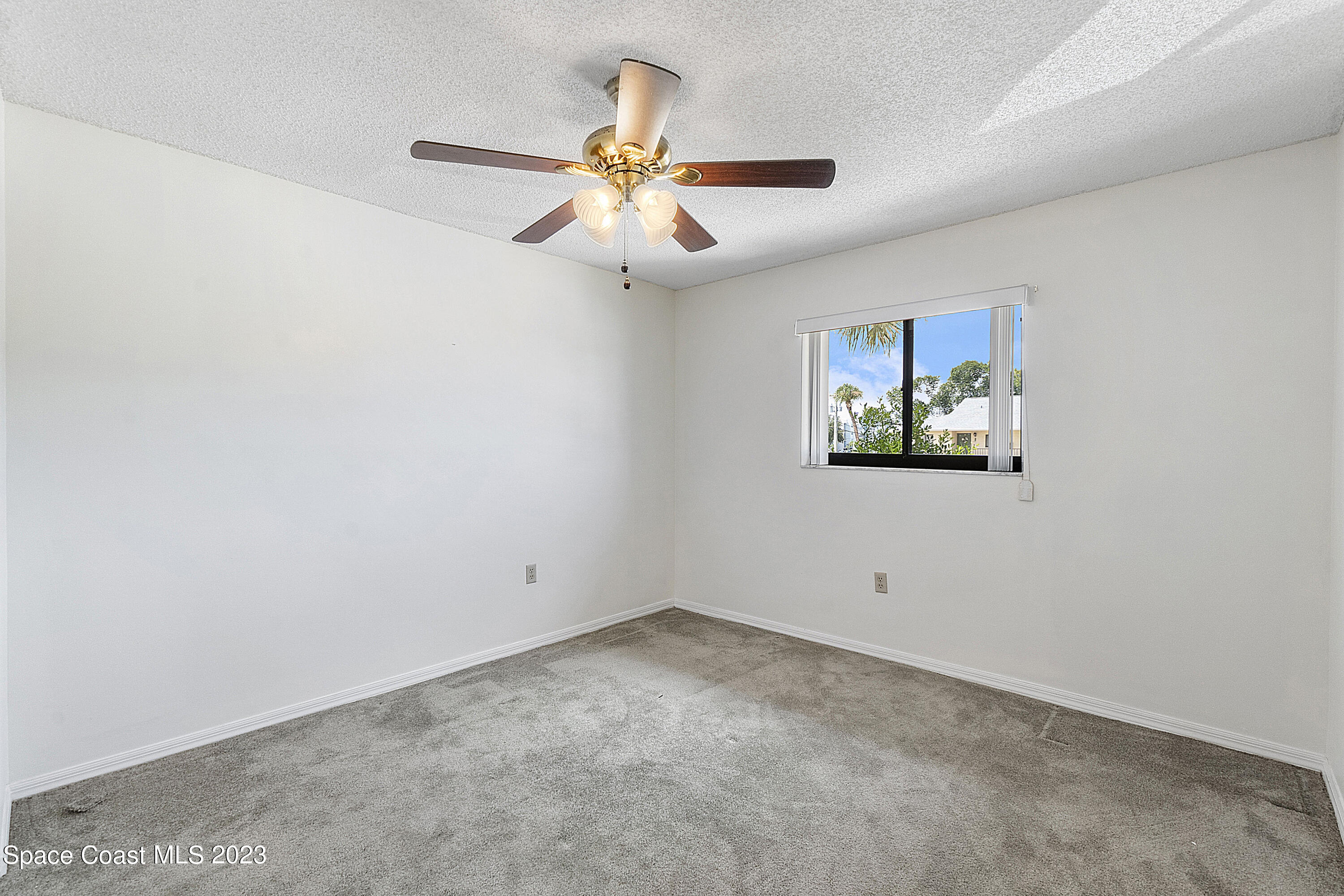 1720 Murrell Road, Unit 203 Rockledge, FL 32955 - Photo 12 of 13 an empty room with windows and fan