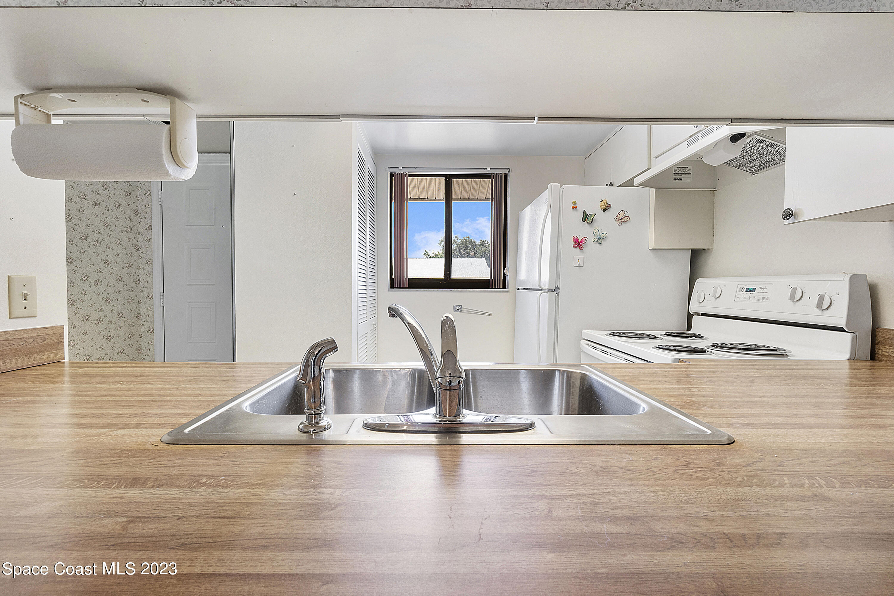 1720 Murrell Road, Unit 203 Rockledge, FL 32955 - Photo 5 of 13 a view with a kitchen counter space and wooden floor