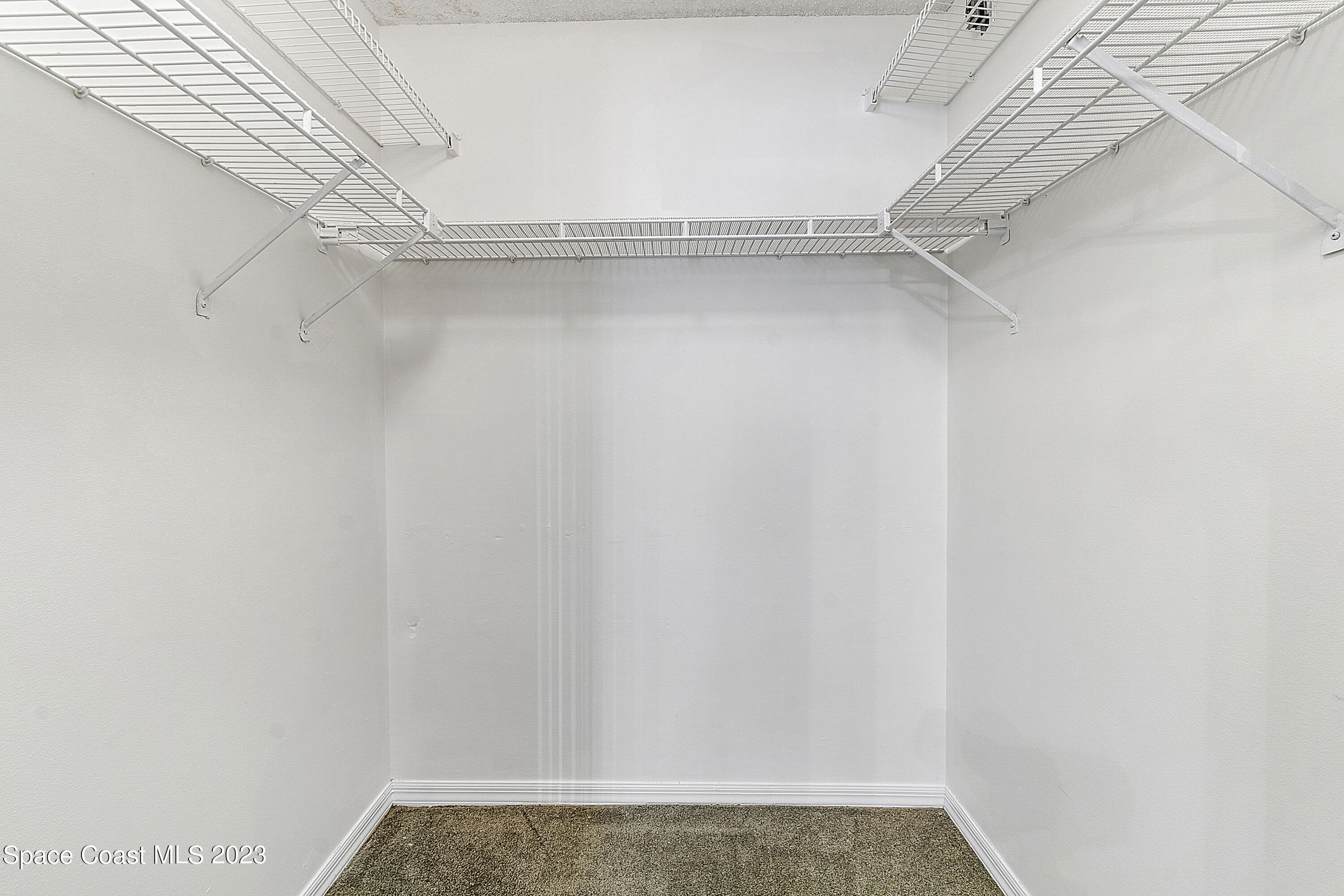 1720 Murrell Road, Unit 203 Rockledge, FL 32955 - Photo 8 of 13 a view of a room with racks on the wall