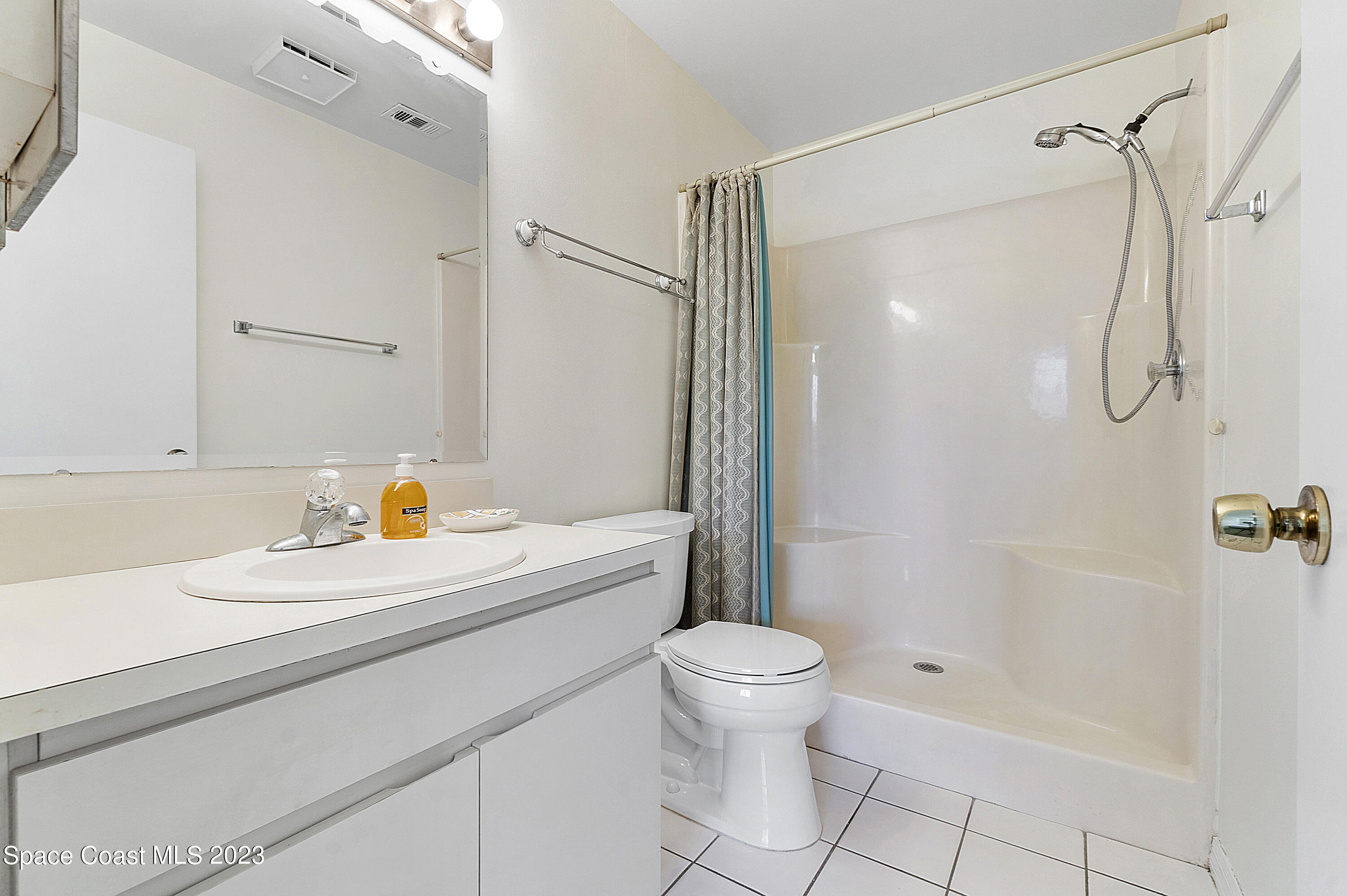 1720 Murrell Road, Unit 203 Rockledge, FL 32955 - Photo 10 of 13 a bathroom with a sink a toilet and shower