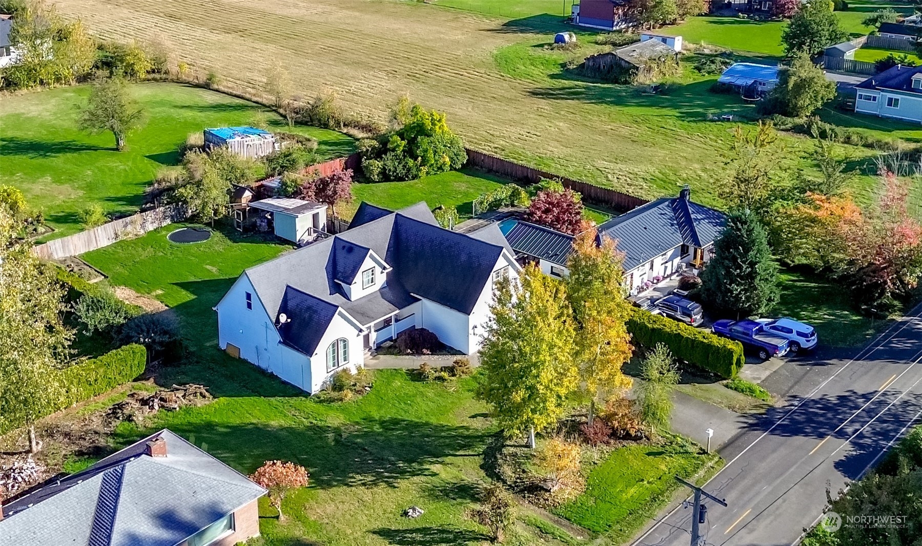 an aerial view of a house with a garden and lake view