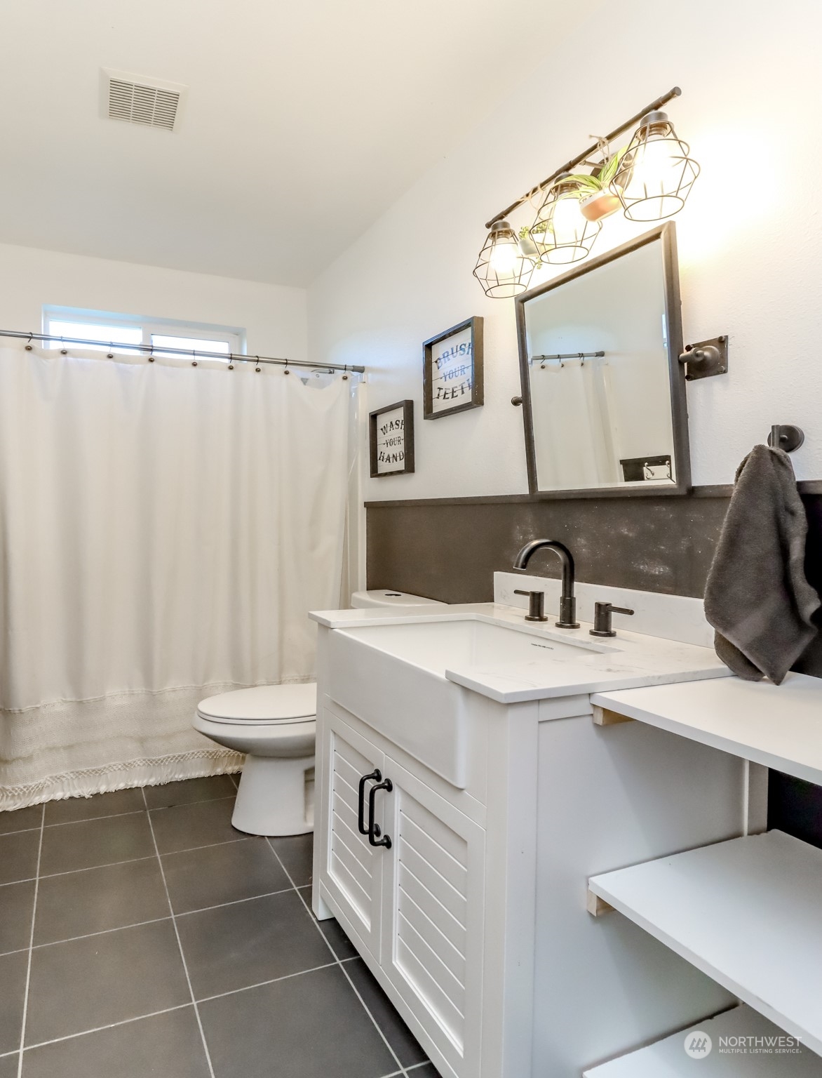 1355 McHugh Avenue Enumclaw, WA 98022 - Photo 15 of 35 a bathroom with a sink and a mirror
