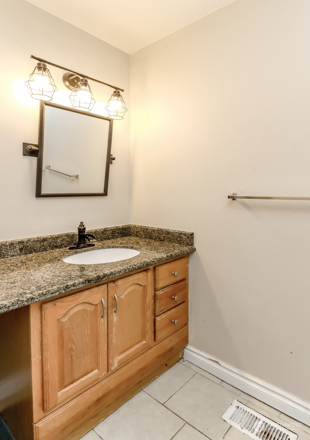 1355 McHugh Avenue Enumclaw, WA 98022 - Photo 17 of 35 a bathroom with a granite countertop sink and a mirror