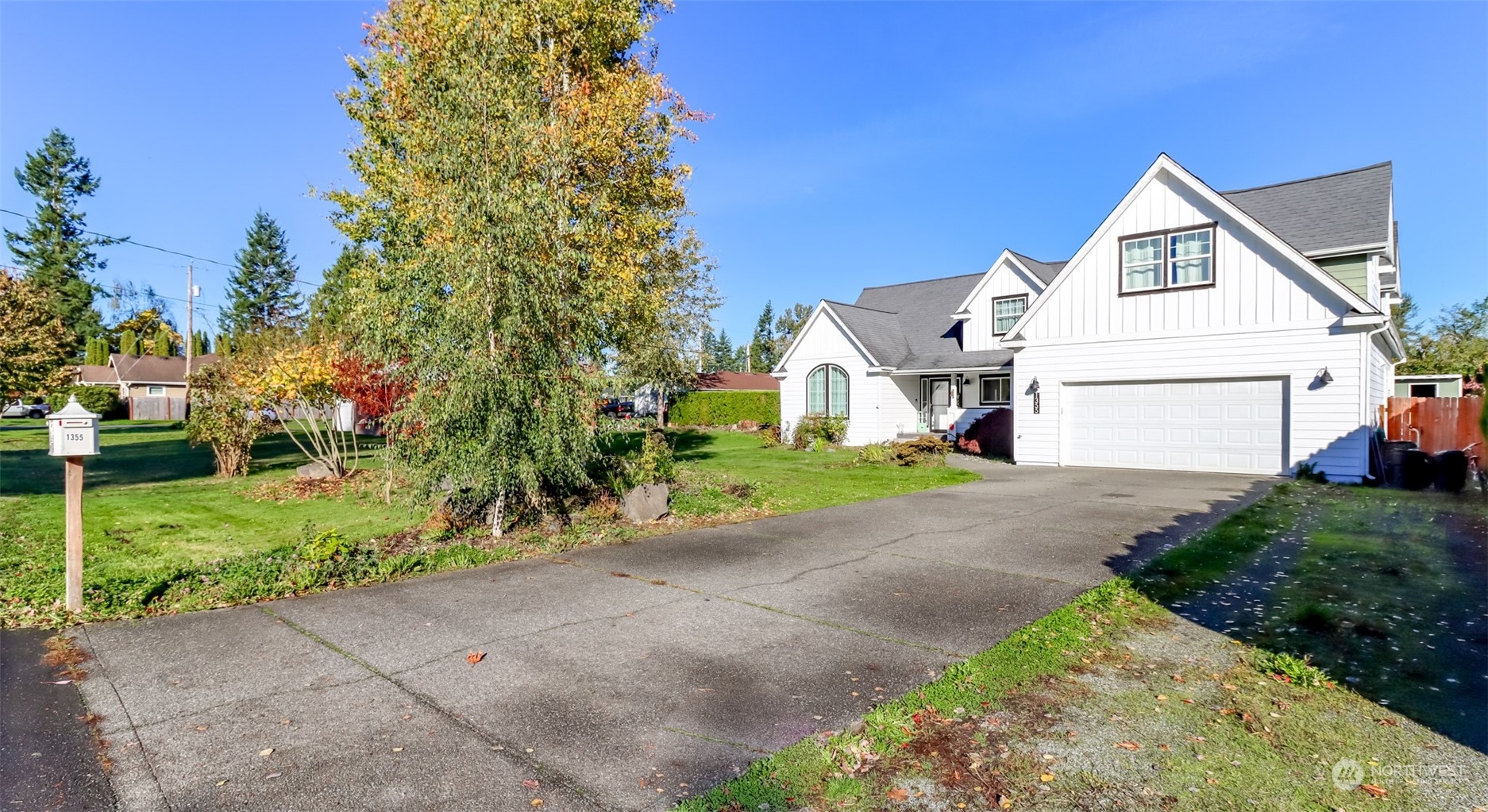 1355 McHugh Avenue Enumclaw, WA 98022 - Photo 2 of 35 a view of a white house with a small yard and a large parking space