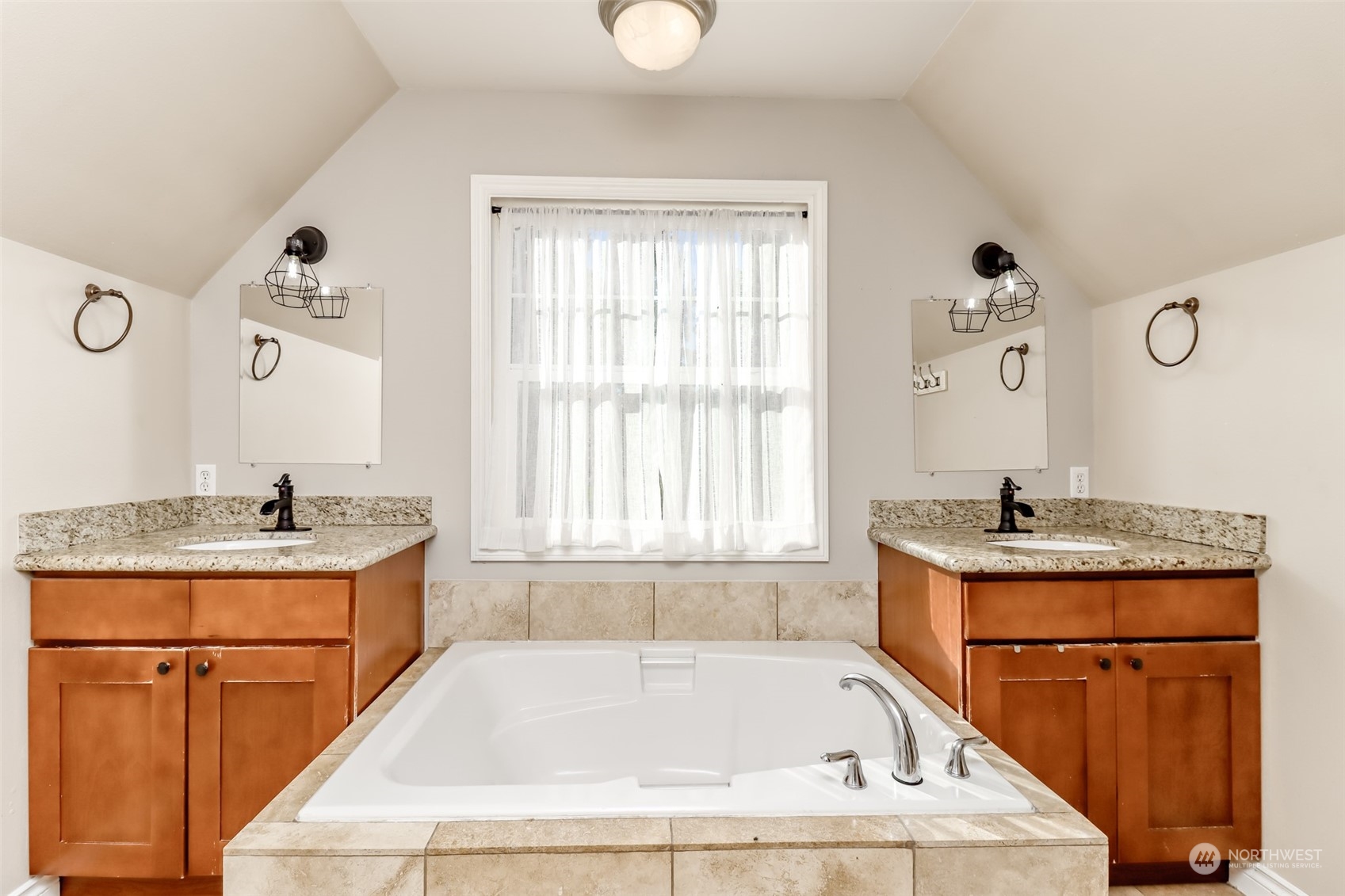 1355 McHugh Avenue Enumclaw, WA 98022 - Photo 28 of 35 a bathroom with a granite countertop tub sink and mirror