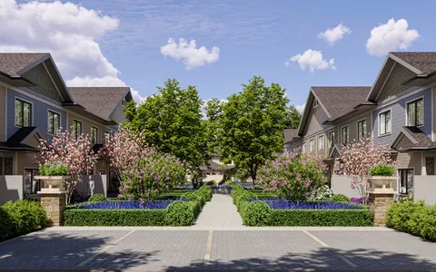 a front view of a house with a yard and fountain in middle