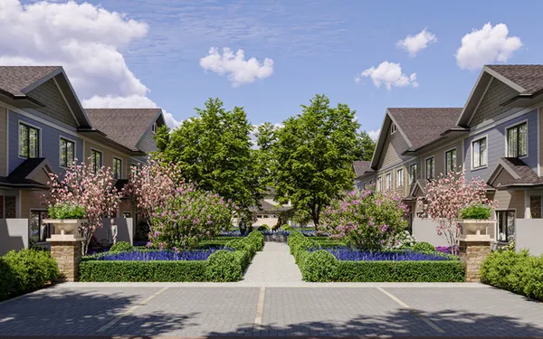 a front view of a house with a yard and fountain in middle