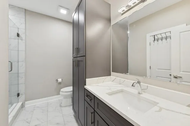 a bathroom with a sink toilet and shower