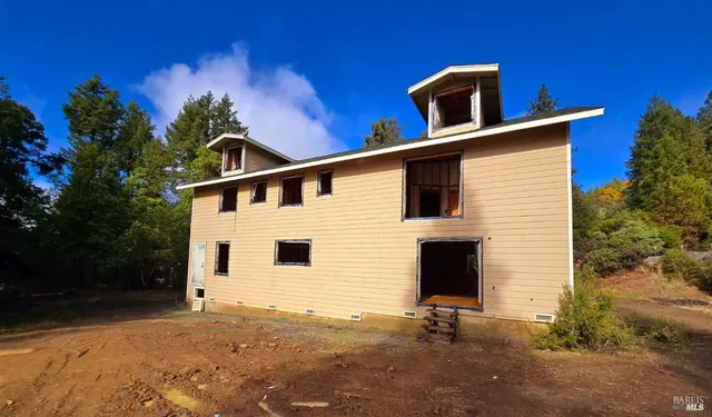 a backyard of a house with table and chairs