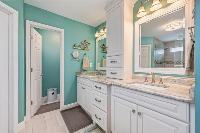a spacious bathroom with a double vanity sink and a mirror