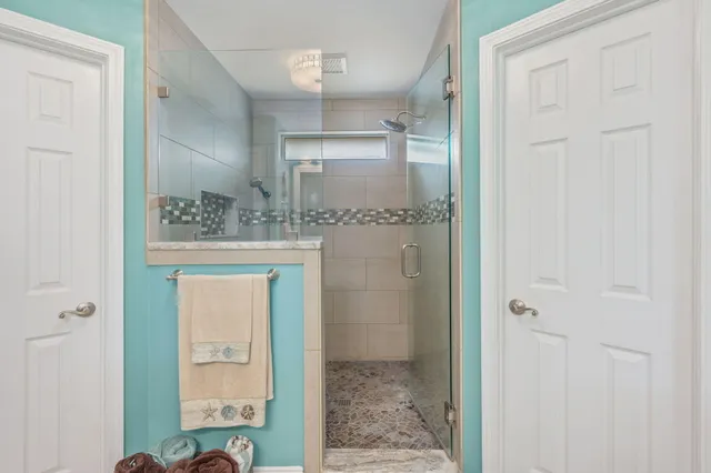 a bathroom with a glass shower door