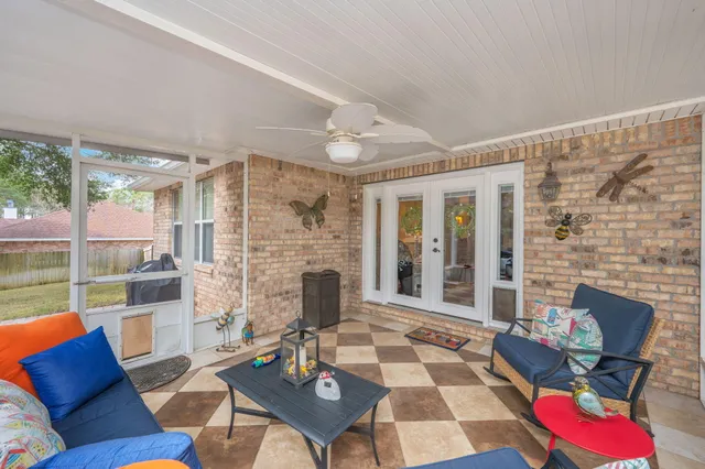 a living room with furniture a fireplace and a floor to ceiling window