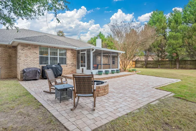 a view of a house with backyard and sitting area
