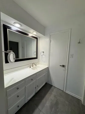 a view of an empty room with window and a livingroom