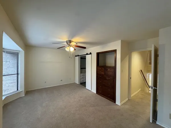 an empty room with closet and a bathroom