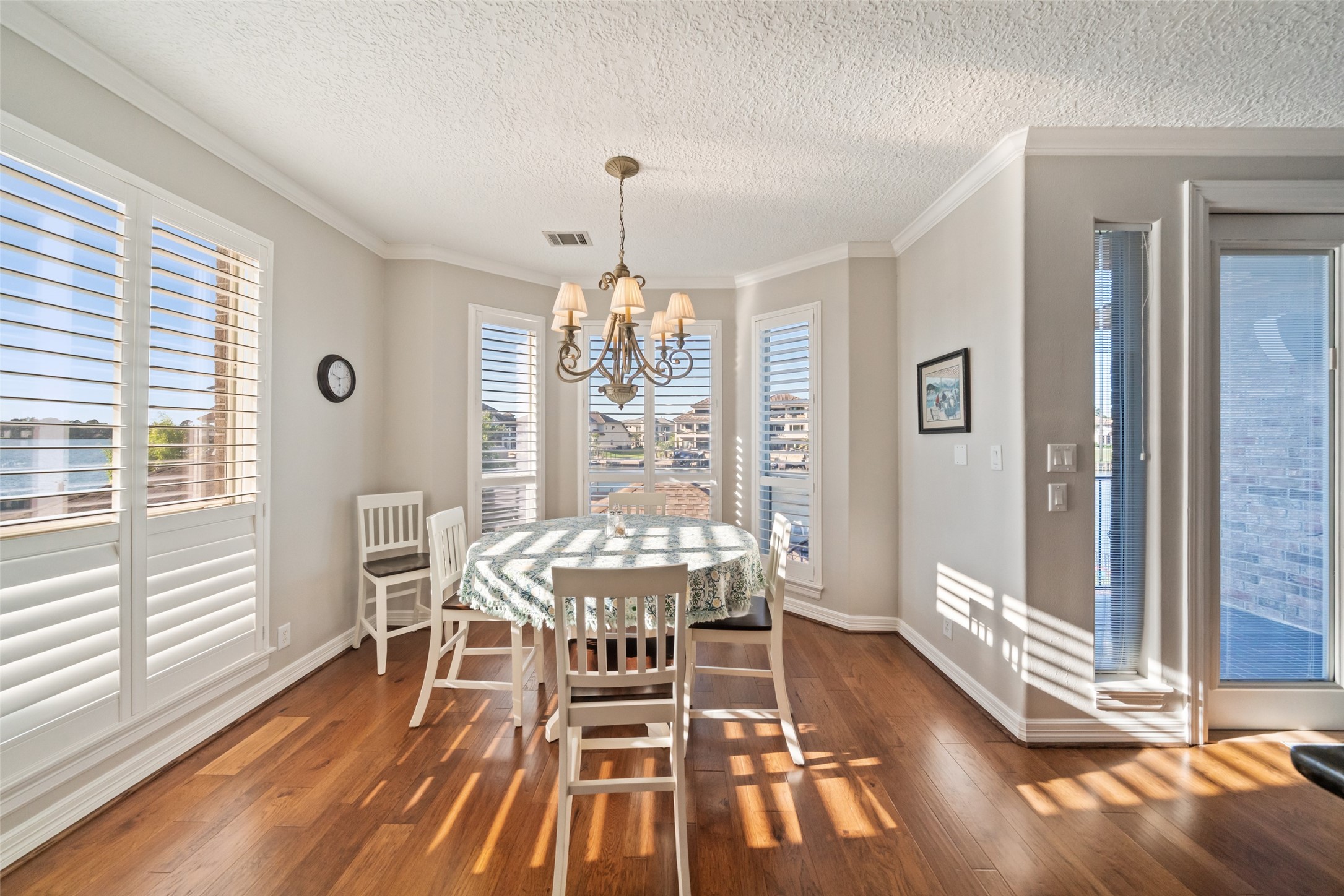 12200 Pebble View Drive Conroe, TX 77304 - Photo 12 of 43 a view of a dining room with furniture wooden floor and chandelier