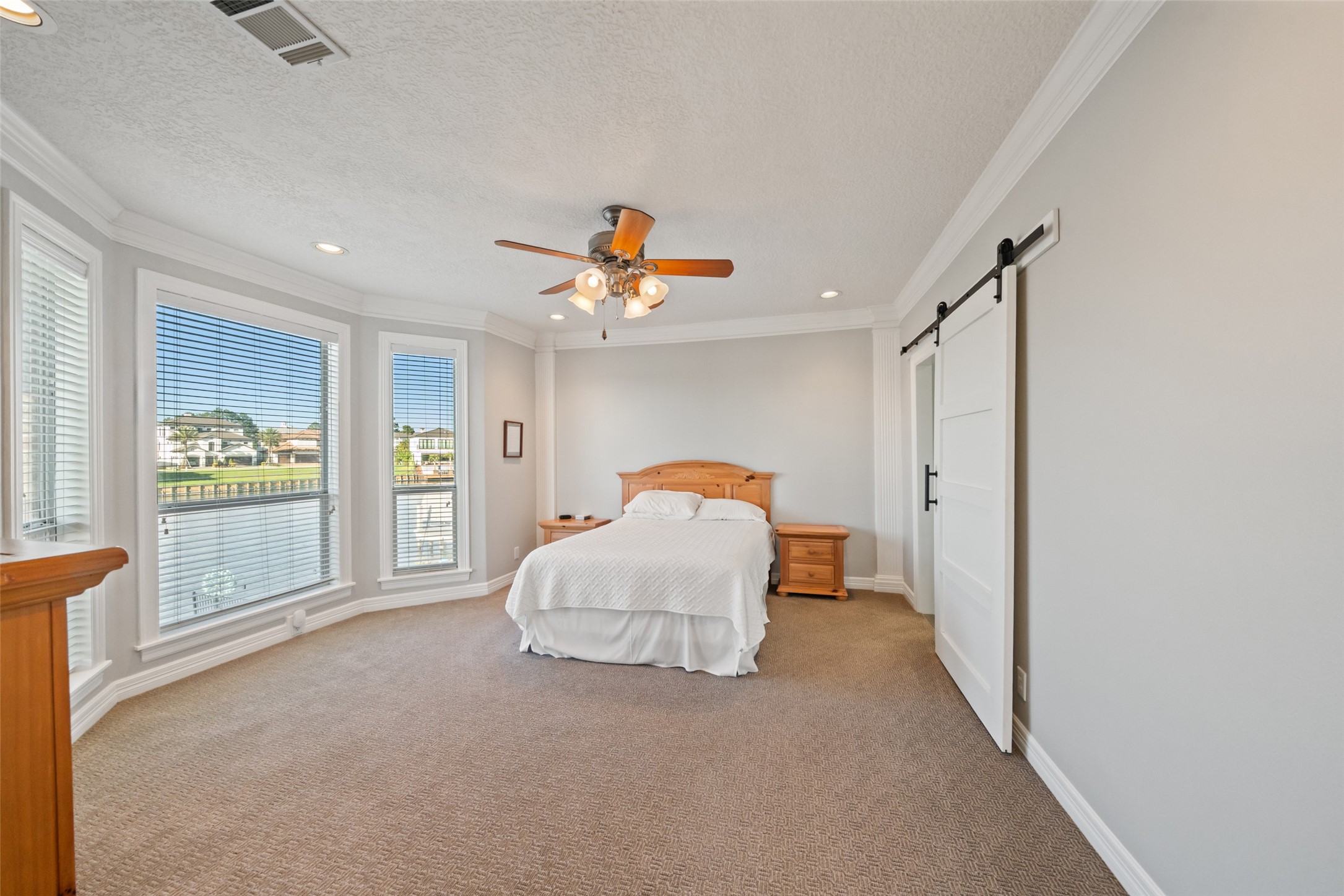12200 Pebble View Drive Conroe, TX 77304 - Photo 14 of 43 a bedroom with a bed and a large window
