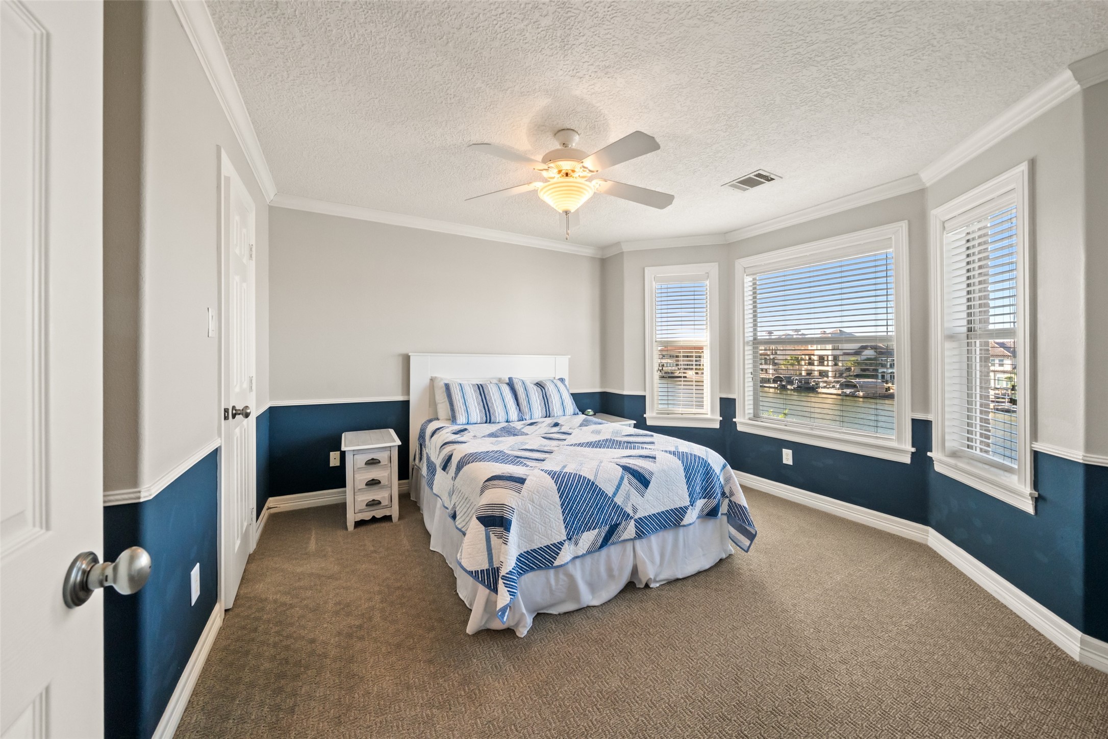 12200 Pebble View Drive Conroe, TX 77304 - Photo 21 of 43 a spacious bedroom with a bed and a window
