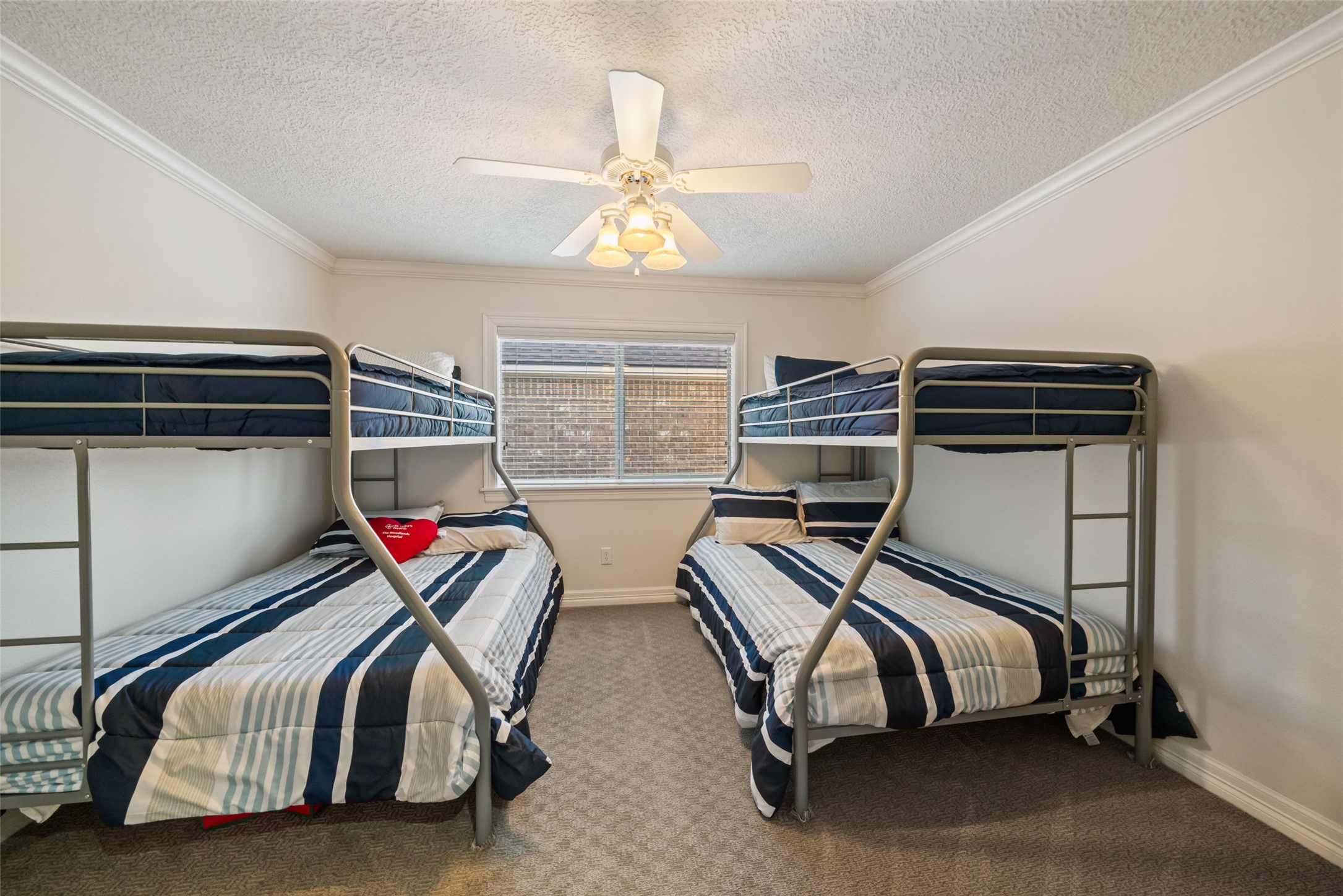 12200 Pebble View Drive Conroe, TX 77304 - Photo 24 of 43 a bedroom with double bunk beds and a window