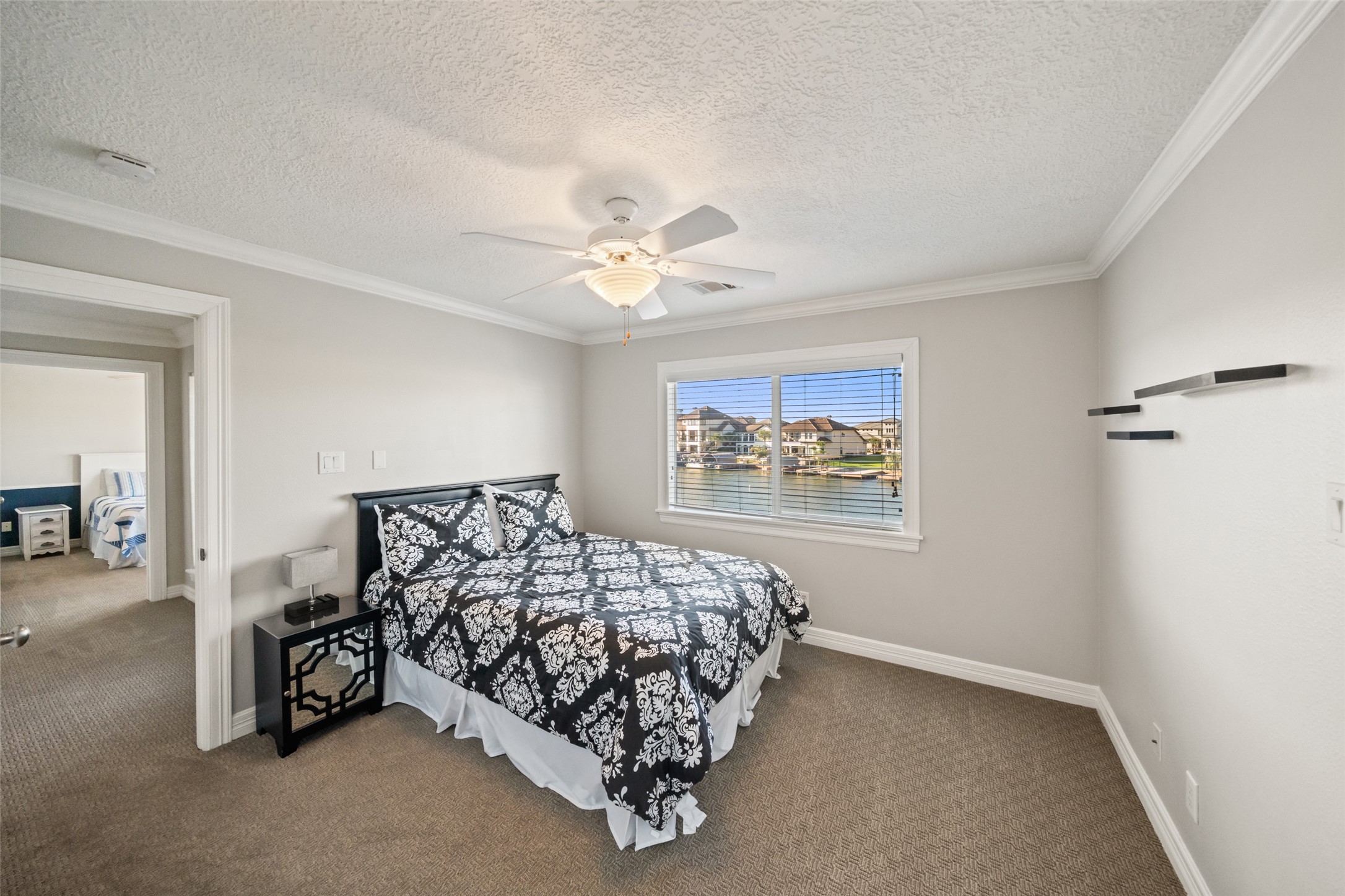 12200 Pebble View Drive Conroe, TX 77304 - Photo 26 of 43 a bedroom with a bed and a chandelier