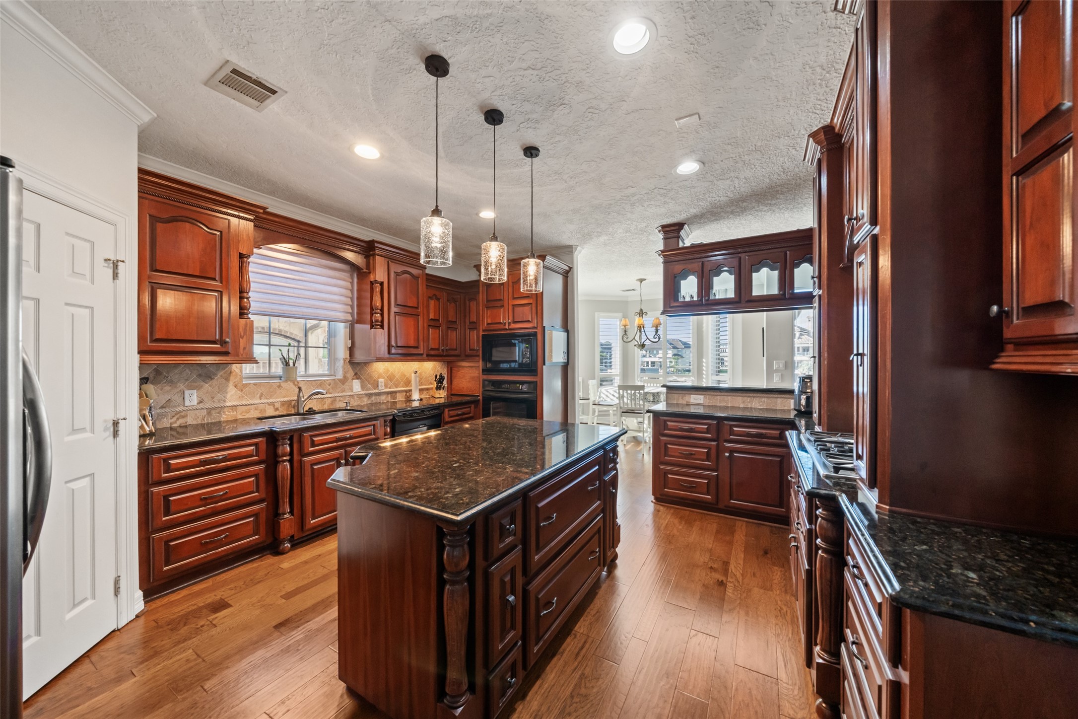 12200 Pebble View Drive Conroe, TX 77304 - Photo 8 of 43 a kitchen with stainless steel appliances granite countertop a stove and a refrigerator