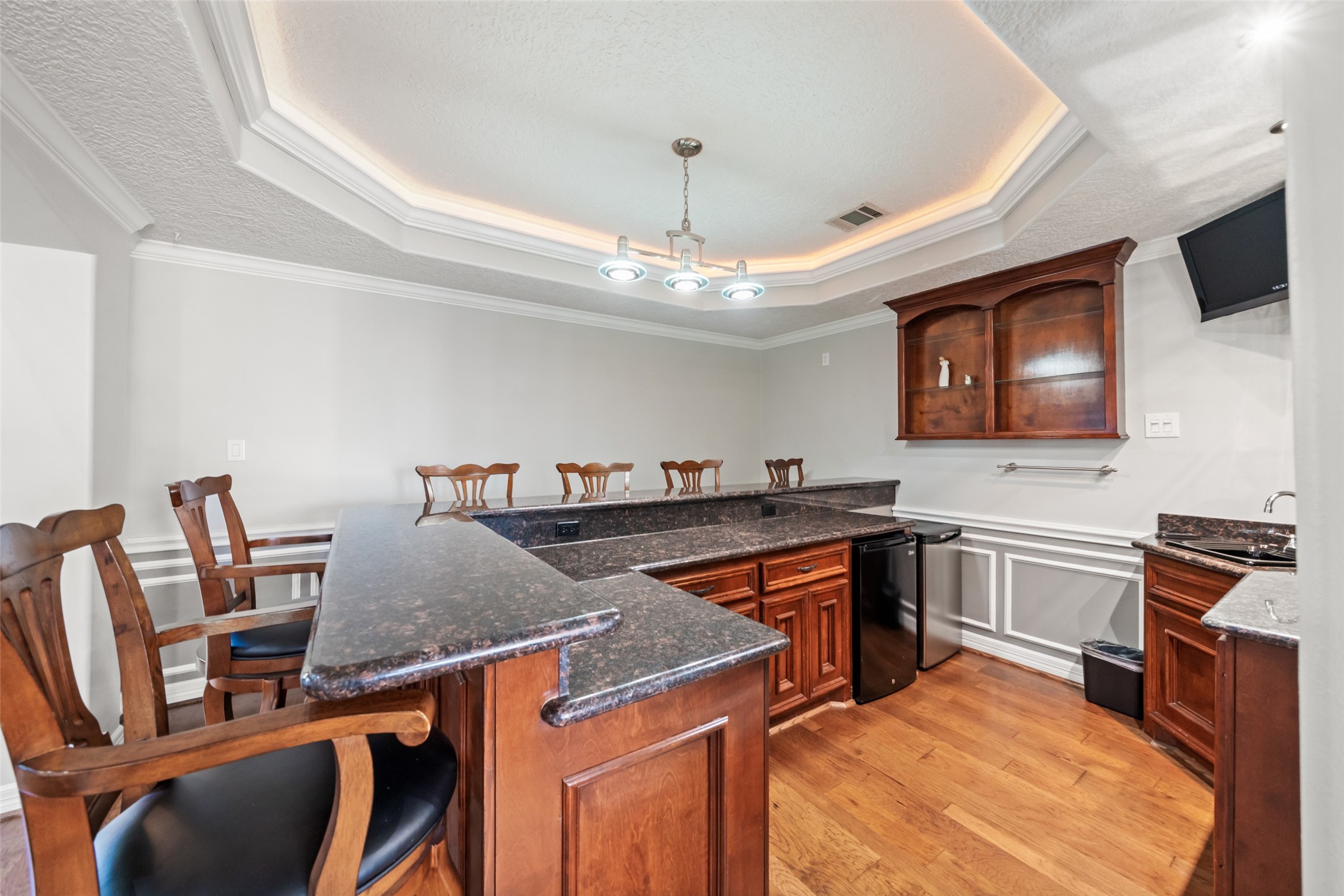 12200 Pebble View Drive Conroe, TX 77304 - Photo 9 of 43 a kitchen with stainless steel appliances granite countertop a stove top oven a dining table and chairs with wooden floor