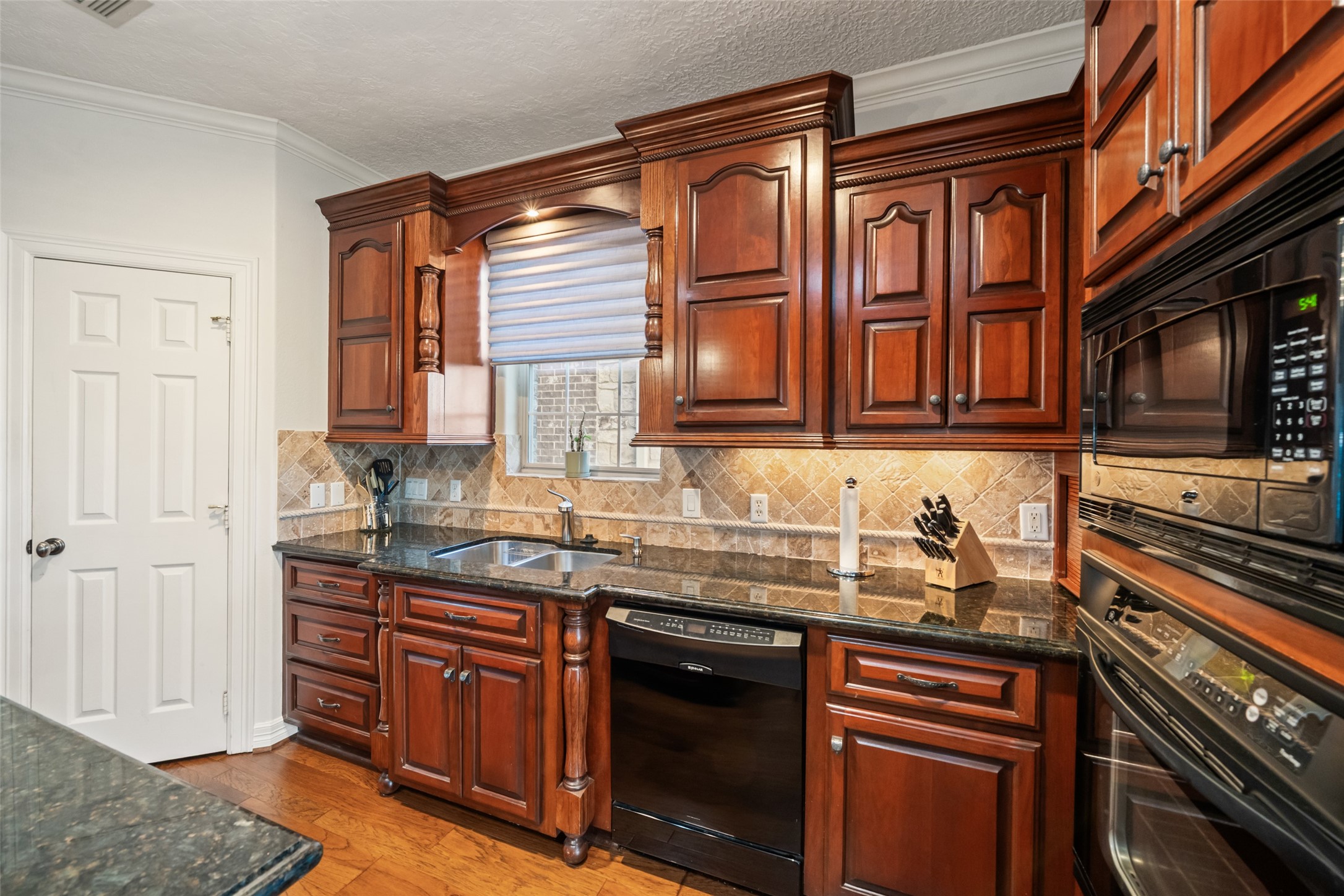 12200 Pebble View Drive Conroe, TX 77304 - Photo 10 of 43 a kitchen with stainless steel appliances granite countertop a sink stove and cabinets