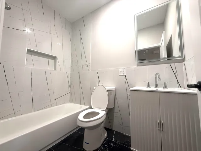 a bathroom with a toilet sink and bathtub