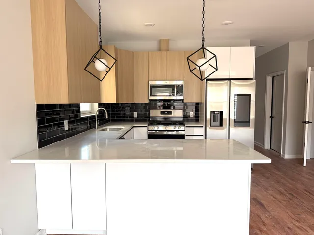 a view of living room with kitchen island furniture and wooden floor