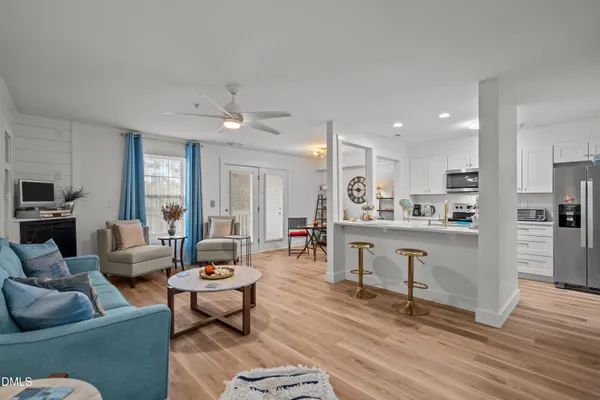 a living room with furniture and a wooden floor