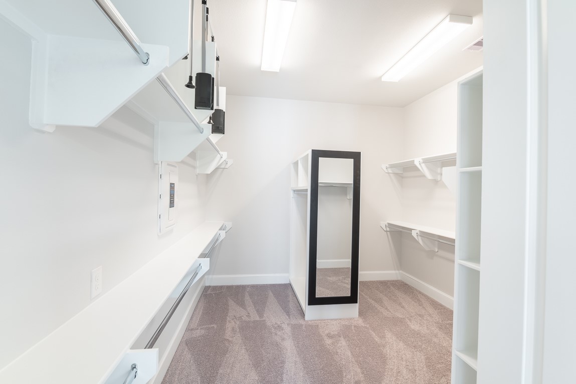 642 Delmar Street Houston, TX 77023 - Photo 15 of 23 Primary closet is almost the size of a secondary bedroom with pull down racks, a dressing mirror and nice well constructed shelving.