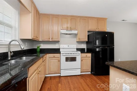 a kitchen with a stove and a refrigerator