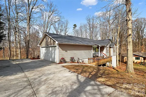 a view of a house with a yard covered in snow