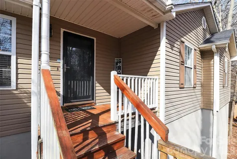 a view of balcony with wooden floor and stairs
