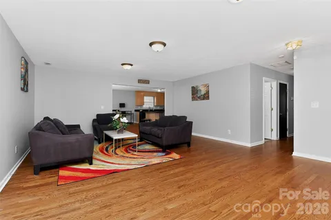 a living room with furniture flat screen tv and rug floor