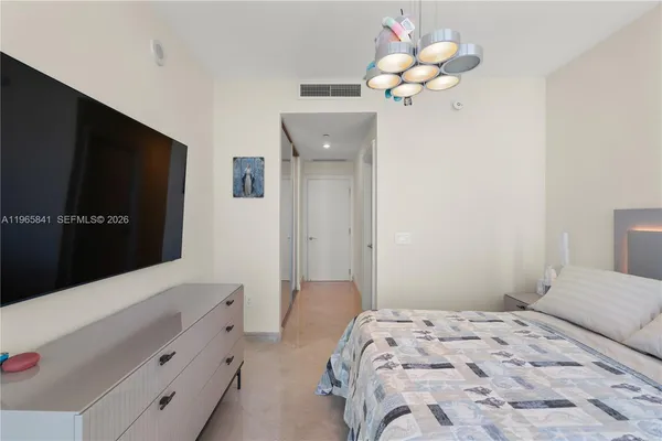 a bedroom with a large bed and a large window