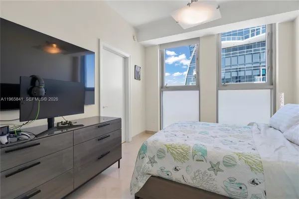 a bedroom with a bed and a lamp