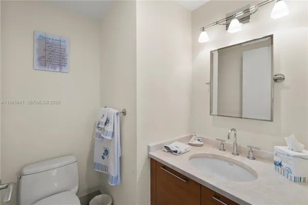 a bathroom with a sink toilet and a mirror