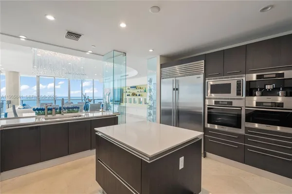 a kitchen with a stove a refrigerator and a sink