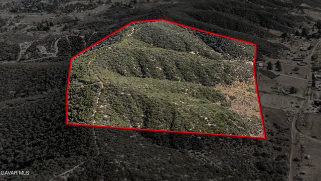 a view of a wooden house with a yard