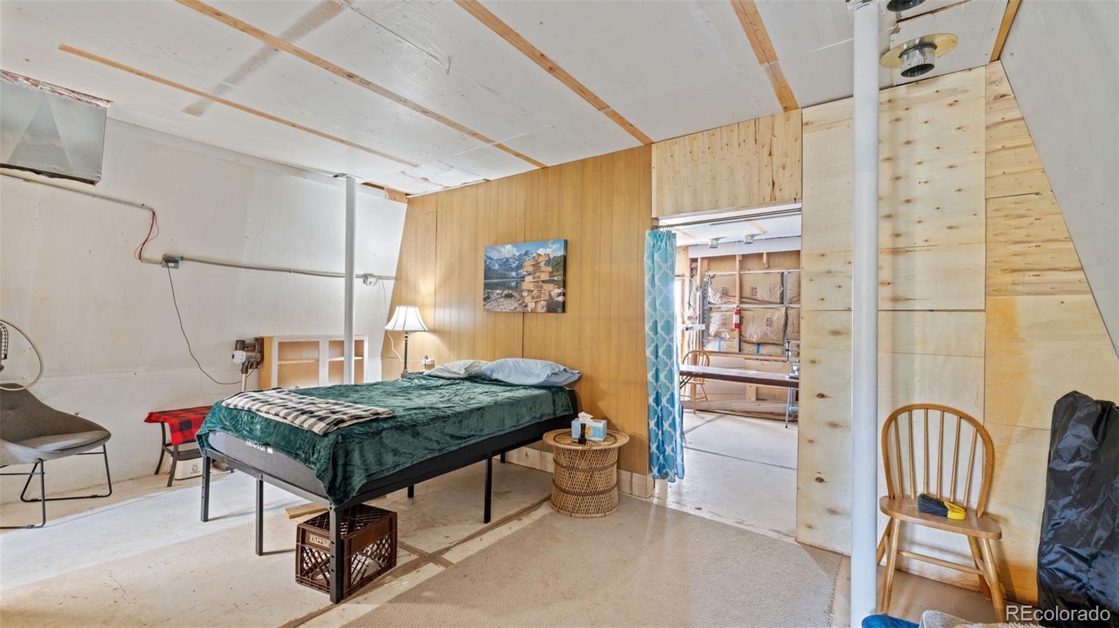 2904 Siloam Road Pueblo, CO 81005 - Photo 25 of 34 a bedroom with a bed and a table